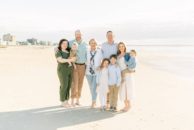 extended family session on the beach in blue and green By Carrie Pellerin
