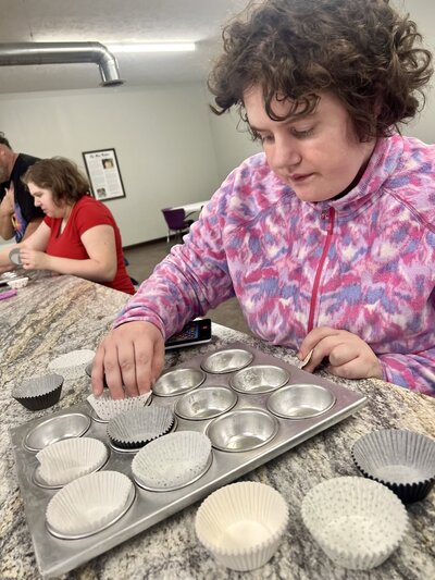 Image of solid rock friend baking muffins..