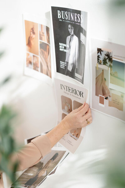 Kaitlyn David arranging a moodboard wall 