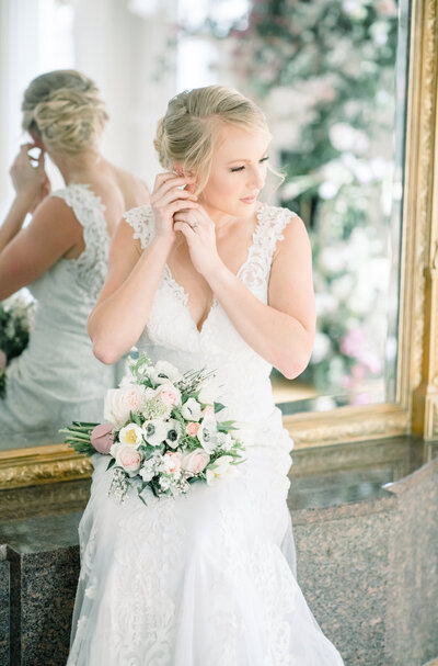 Bride getting ready in front of large mirror at Marion Hatcher Center, Augusta Wedding Photographer