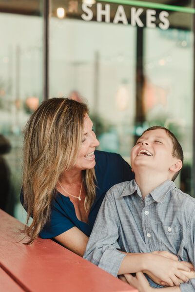 a mom laughing with her son
