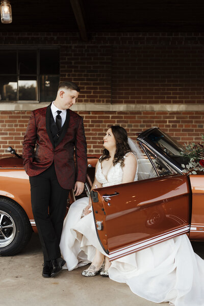 Bride and groom in mustang getaway car