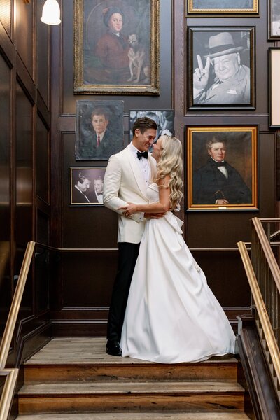 bride and groom pose on top of stairs at tampa harborside chapel, fl