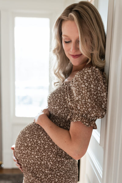 Maternity photo of a mom holding her belly.