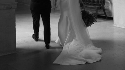 rainy day wedding photo of couple posing with umbrella