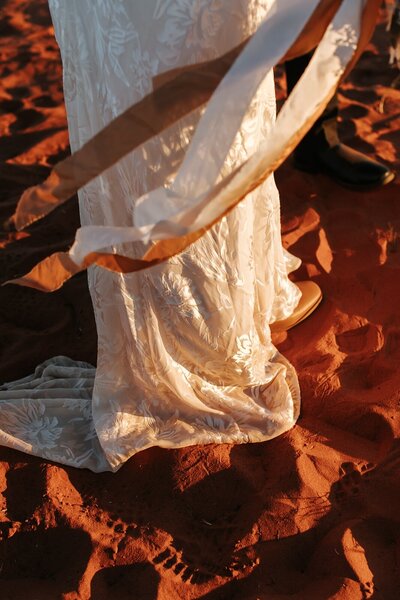 A white wedding dress flowing in the red dirt of the Australian outback
