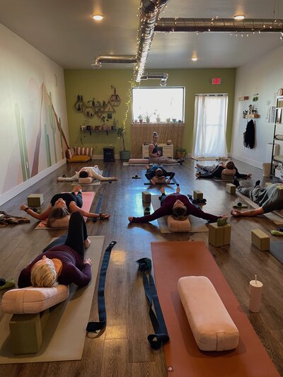 Yoga class in forward fold