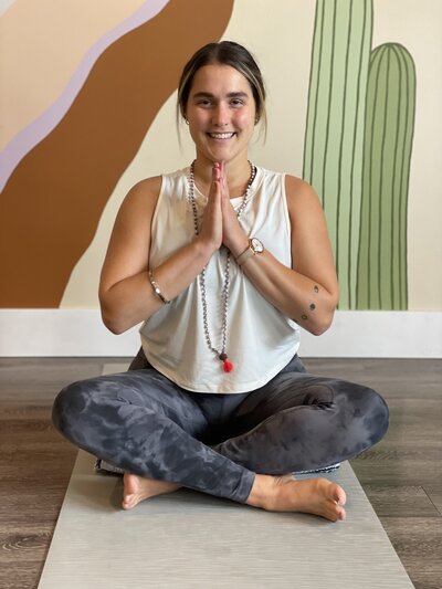 Ariane meditating in a field of flowers