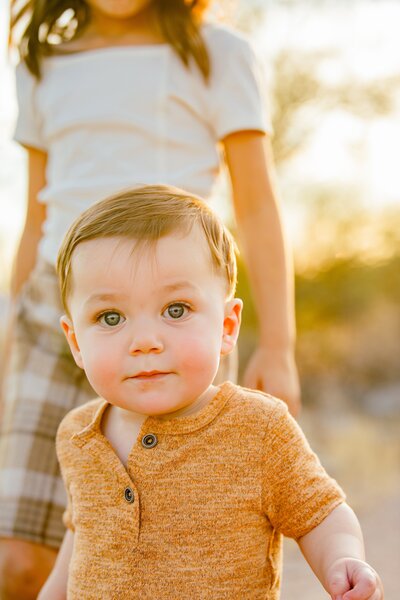 little boy walking toward camera in the arizona desert 