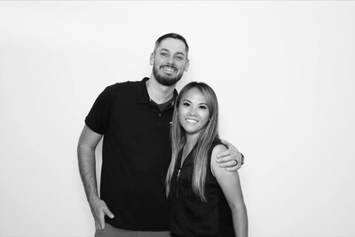 Boise Photo Booth and Portrait Photographers Zak & Noy Tellefson smile at the camera representing their participation in the Crush Collective wedding expo.