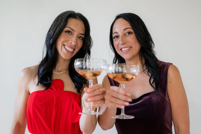 Stef and Tara clinking champagne glasses