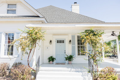 A charming blue and white home that has been converted into a studio rental space