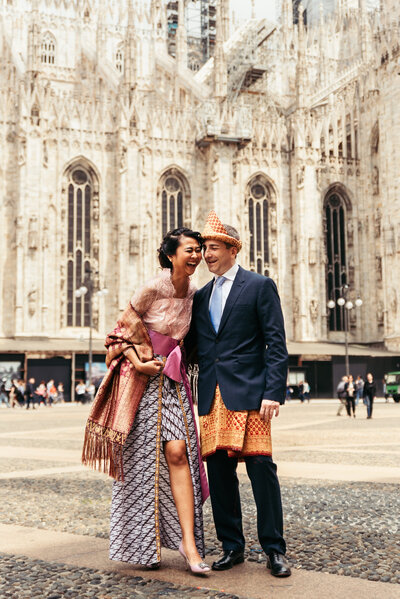 The bride and groom share laughter against the iconic backdrop of the Duomo, capturing the happiness and love that radiate on their special day in this vibrant Italian city