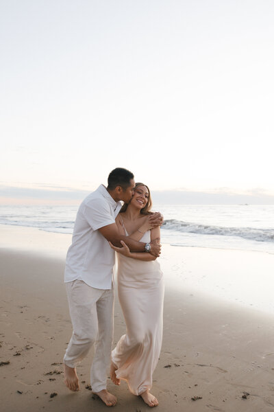 couple running on beach at elopement