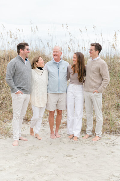 A Hilton Head family in Palmetto Dunes is posing for a beach photography session with Hilton Head Photographer, Lamp and Light Photography.