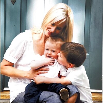 mom sitting with her two sons on porch steps