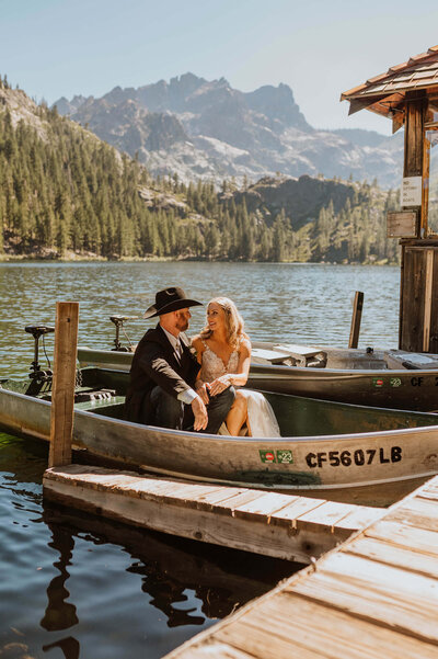 A couple sitting in a boat on their wedding day