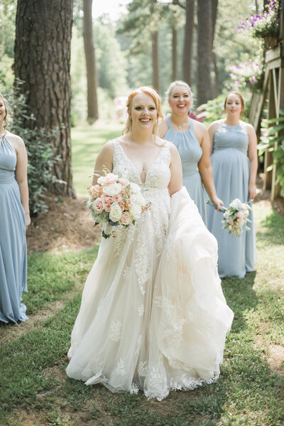 bride walking with bridesmaids and smiling