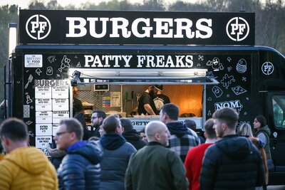 Patty Freaks Food Truck at Street Food Event. Quese of people at night, dressed in warm clothing and queuing for burgers