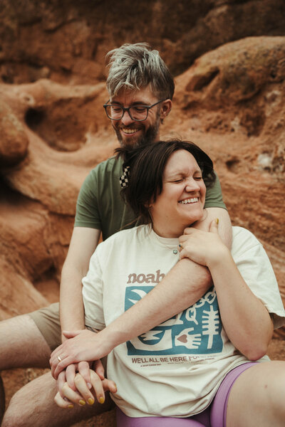Couple laughs while in rocky mountain space