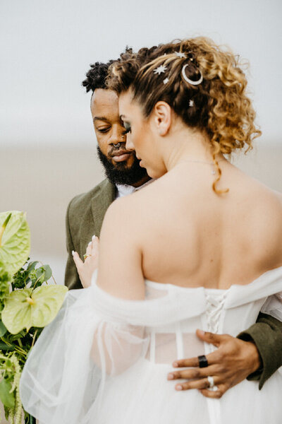 groom holding bride lovingly and closely