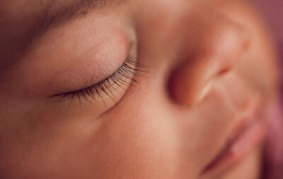  Close-up of a baby's eyes, showcasing delicate eyelashes and sweet details.