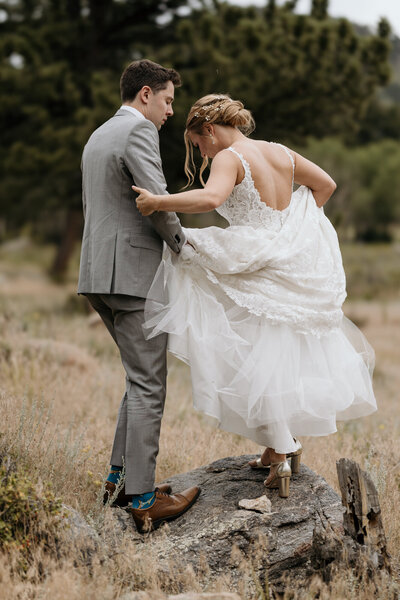 Groom helps Bride during Rocky Mountain National Park adventure elopement.