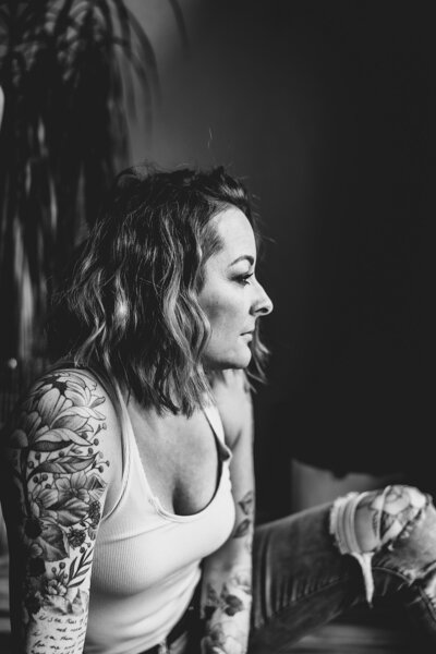 Oregon photographer with tattoos smiling at camera