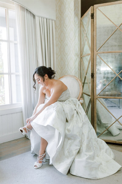 Bride putting her wedding shoes on