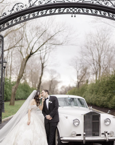 bride and groom with car