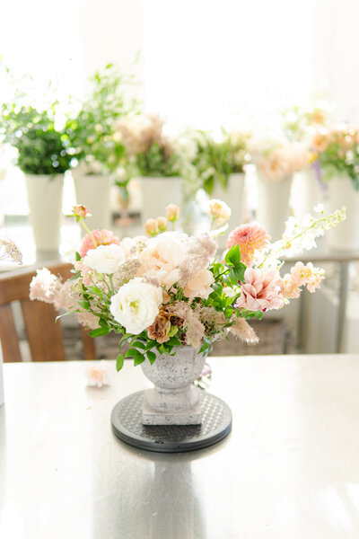 Southern California florist, Elsa from Verde Olivo Floral is designing a wedding centerpiece  in her floral studio.