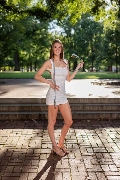 a girl posing at the state house in Columbia, SC for her high school senior portraits