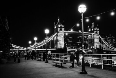 A surprise proposal at Butler's Wharf Pier, Tower Bridge, at night.