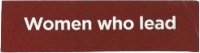 Red rectangle cut out from magazine with white text stating "Women who lead," conveying empowerment and leadership for women. Simple and bold design.