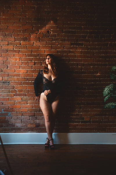 Lady with a  black bodysuit and black heels on fer her Nashville Boudoir photography session