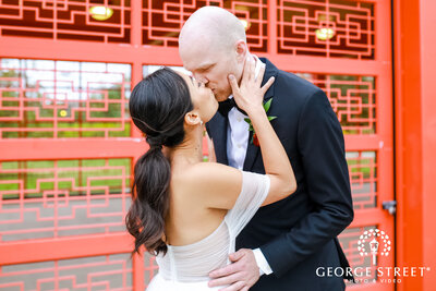 A fall wedding couple kissing at Ping Tom Park, Chicago, IL, multicultural wedding