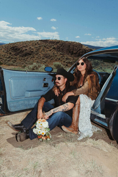 Couple with vintage car for their Woodstock inspired elopement