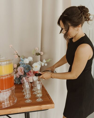 Makeup artist celebrating Michelle Shaw Makeup Masterclass with champagne.