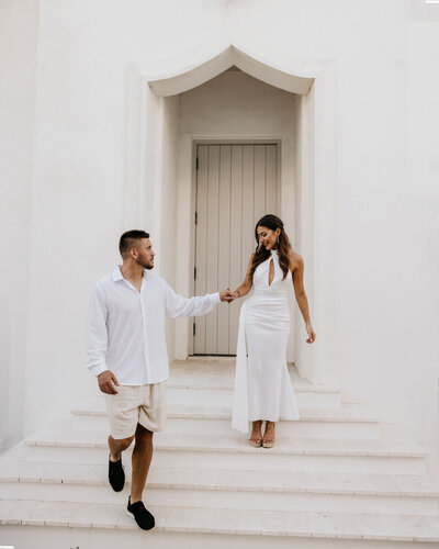 bride and groom walk down steps