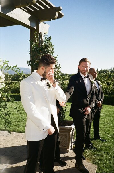 a groom crying during a wedding ceremony