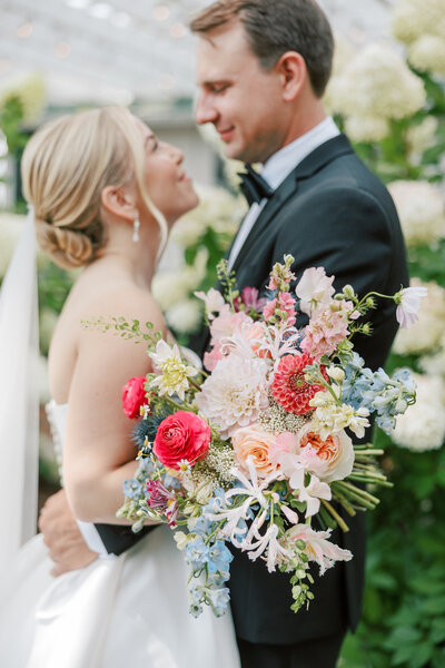 close up of bride and groom with flowers