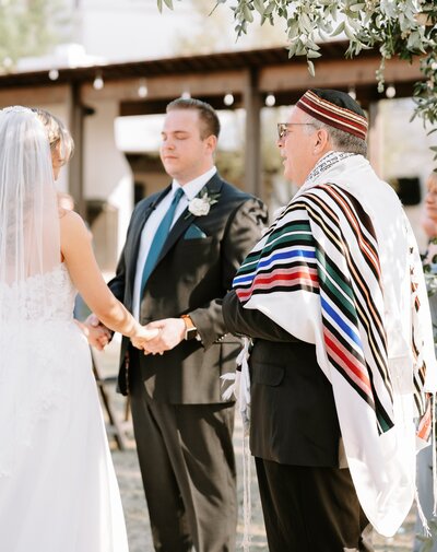 Picture of bride and groom during Jewish ceremony taken by Wedding Photographer in Texas