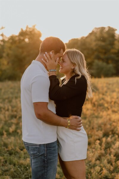Engagement photo of a couple at sunset in Wyoming, with a romantic outdoor setting and soft natural lighting.
