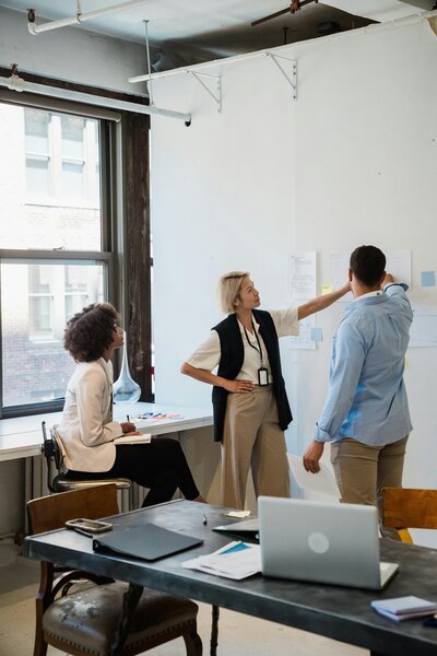 Women participating in a group coaching session focused on career development, seated in a conference room setting to discuss strategies for advancing their professional goals.