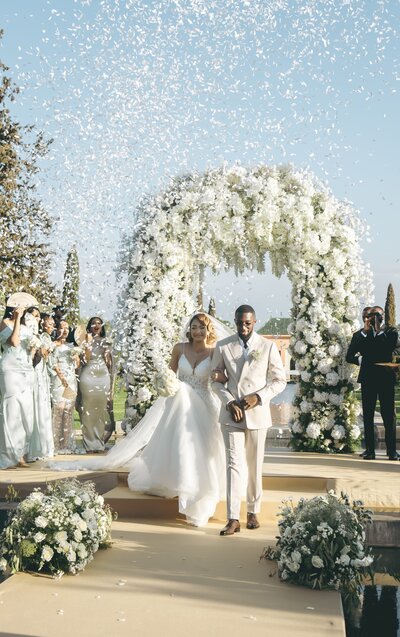 Bride and Groom Under Flower Arch