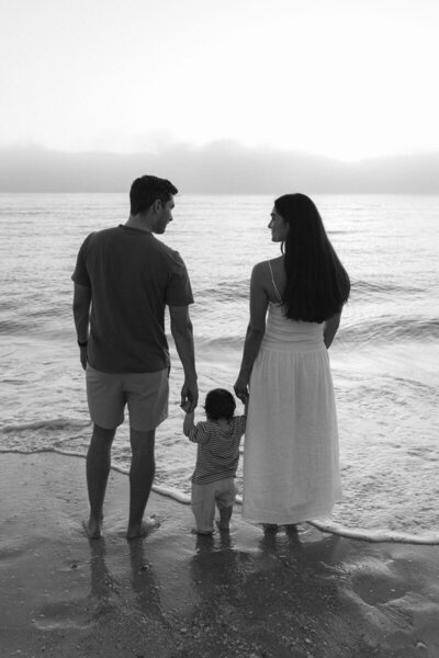 family holding hands on beach during sunset by photographer marco island