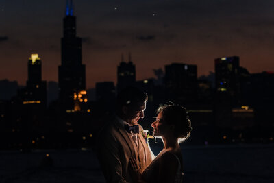 Bride and room share a moment at night at the Adler Planetarium in Chicago, IL