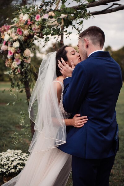 Romantic first kiss for backyard wedding in New England