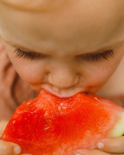 Close-up of baby girl sneezing with a cute expression during a family photo session