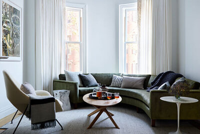 A brownstone renovation blending historic charm with modern furniture, creating a sophisticated and livable interior in Boston.